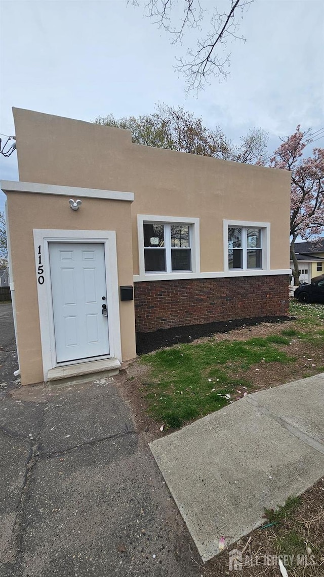 1150 Rahway Ave, Avenel, NJ 07001 - view of front of home with stucco siding and brick siding
