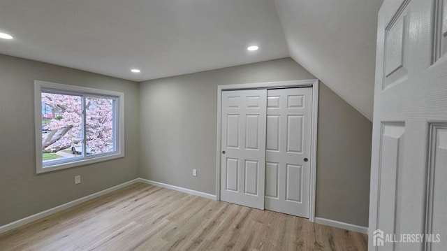 1150 Rahway Ave, Avenel, NJ 07001 - unfurnished bedroom with light wood finished floors, vaulted ceiling, recessed lighting, a closet, and baseboards