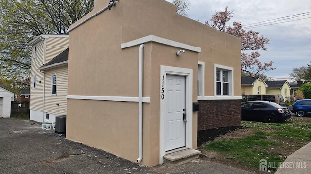 1150 Rahway Ave, Avenel, NJ 07001 - view of front of home with cooling unit and stucco siding