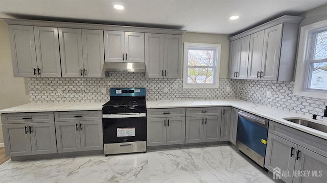 1150 Rahway Ave, Avenel, NJ 07001 - kitchen with appliances with stainless steel finishes, gray cabinets, under cabinet range hood, light marble finish floors, and light stone countertops
