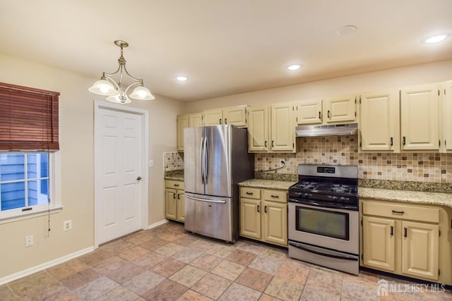 kitchen featuring under cabinet range hood, appliances with stainless steel finishes, pendant lighting, and backsplash