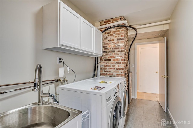 clothes washing area featuring a sink, light tile patterned flooring, cabinet space, and independent washer and dryer