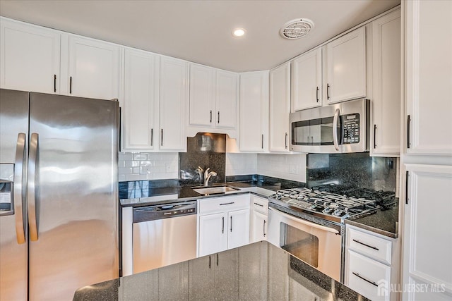 kitchen with white cabinetry, stainless steel appliances, and a sink
