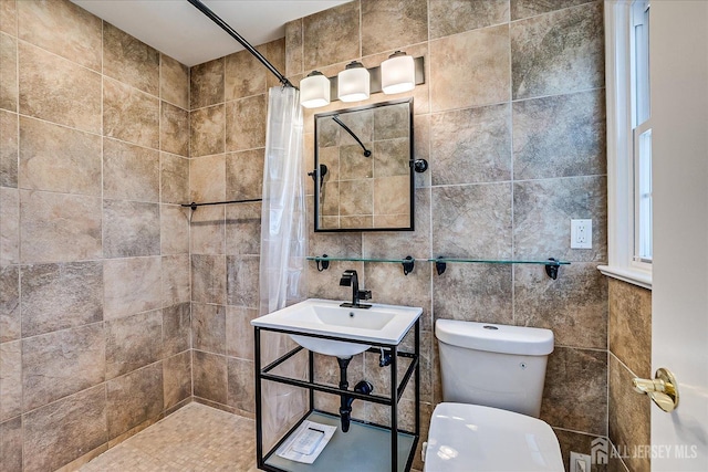 full bathroom featuring tile walls, toilet, and tiled shower