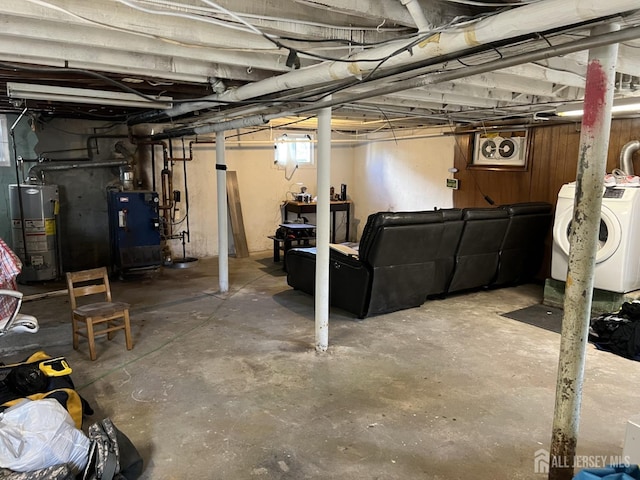 basement featuring gas water heater and washer / dryer