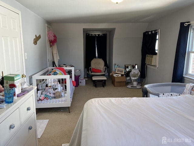 bedroom with cooling unit, light colored carpet, and lofted ceiling