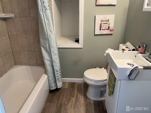 22 State St, Carteret, NJ 07008 - full bathroom with wood finished floors, toilet, vanity, shower / bathtub combination with curtain, and baseboards