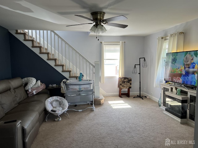 living room featuring light carpet and ceiling fan