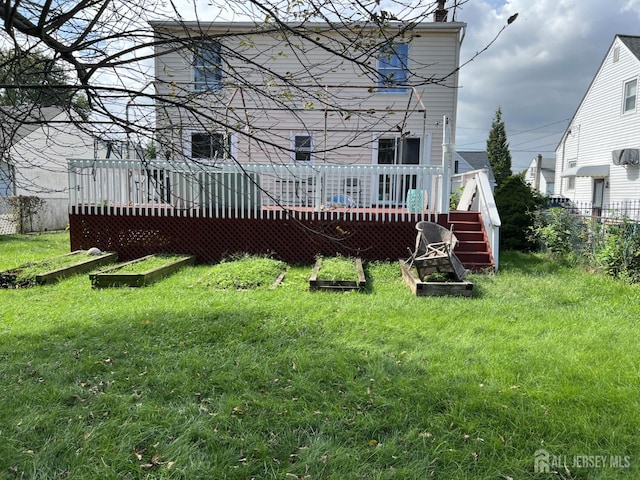 22 State St, Carteret, NJ 07008 - back of house with a wooden deck and a lawn