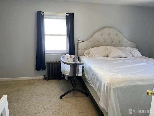 bedroom featuring carpet and radiator