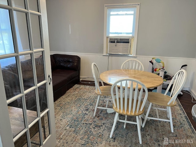 dining space with hardwood / wood-style floors and cooling unit