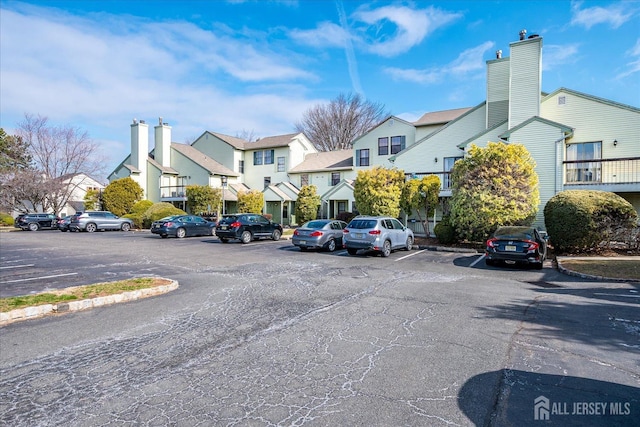 uncovered parking lot featuring a residential view