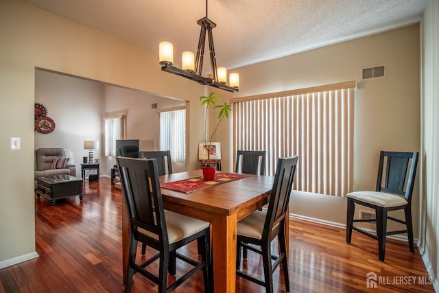 136 Chichester Rd, Monroe, NJ 08831 - dining room featuring a chandelier, wood-type flooring, a textured ceiling, and baseboards