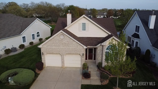 136 Chichester Rd, Monroe, NJ 08831 - traditional home featuring brick siding, driveway, an attached garage, a shingled roof, and a front lawn