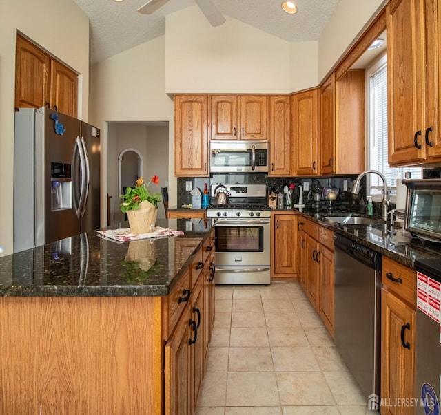 136 Chichester Rd, Monroe, NJ 08831 - kitchen with appliances with stainless steel finishes, a sink, brown cabinetry, tasteful backsplash, and dark stone counters