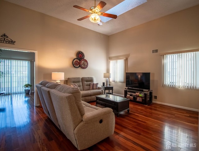 136 Chichester Rd, Monroe, NJ 08831 - living area featuring a ceiling fan, dark wood-type flooring, high vaulted ceiling, baseboards, and a textured ceiling