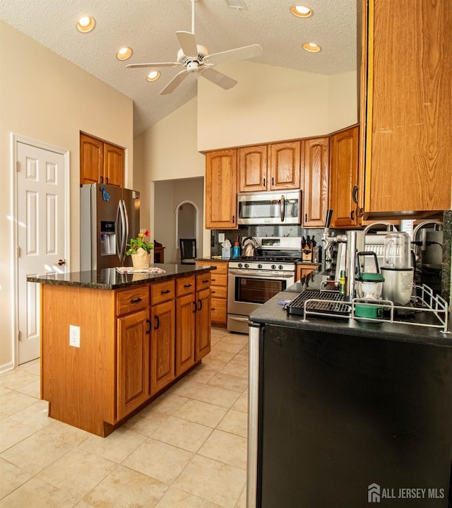 136 Chichester Rd, Monroe, NJ 08831 - kitchen with stainless steel appliances, a textured ceiling, brown cabinets, a ceiling fan, and a center island