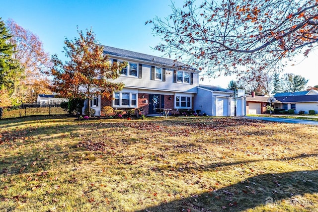 view of front of property featuring a garage and a front yard