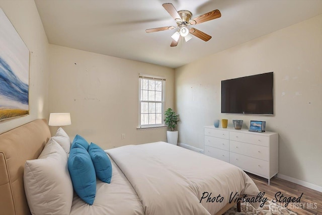 bedroom featuring a ceiling fan, light wood-type flooring, and baseboards