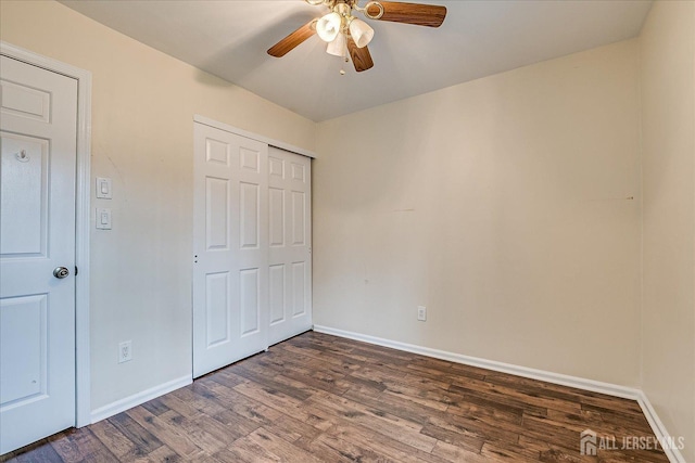 unfurnished bedroom with a closet, baseboards, and wood finished floors