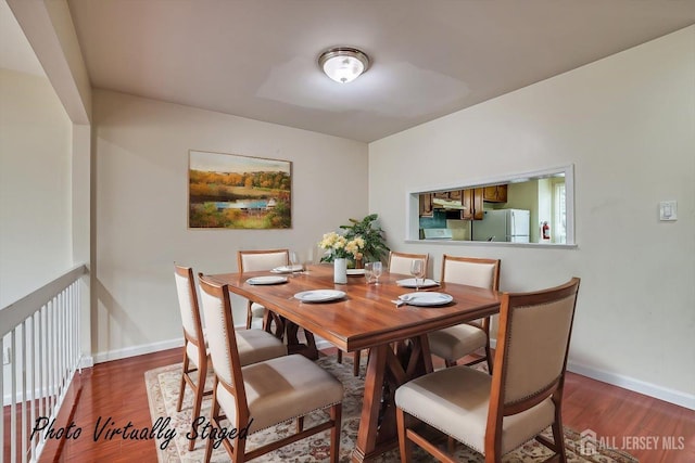 dining room featuring baseboards and wood finished floors