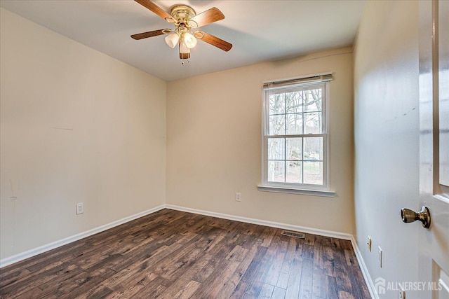 empty room with dark wood-type flooring, visible vents, ceiling fan, and baseboards