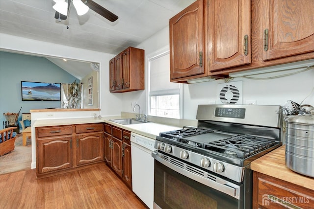 274 Prospect Ave, South Amboy, NJ 08879 - kitchen featuring stainless steel gas stove, dishwasher, a sink, light wood finished floors, and a ceiling fan