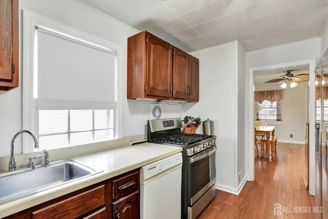 274 Prospect Ave, South Amboy, NJ 08879 - kitchen featuring stainless steel gas range oven, white dishwasher, a sink, a ceiling fan, and light countertops