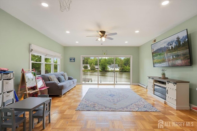 44 Lakeside Dr S, Piscataway, NJ 08854 - living room with a baseboard radiator, a ceiling fan, recessed lighting, a water view, and baseboards