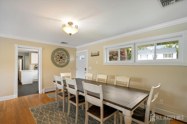 44 Lakeside Dr S, Piscataway, NJ 08854 - dining space featuring crown molding, a baseboard heating unit, wood finished floors, and baseboards