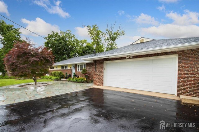 44 Lakeside Dr S, Piscataway, NJ 08854 - single story home featuring asphalt driveway, brick siding, an attached garage, and a shingled roof