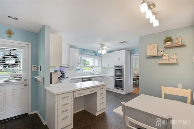 44 Lakeside Dr S, Piscataway, NJ 08854 - kitchen featuring stainless steel appliances, a sink, light countertops, a peninsula, and white cabinets
