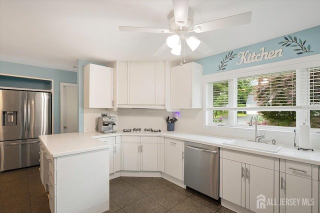 44 Lakeside Dr S, Piscataway, NJ 08854 - kitchen featuring stainless steel appliances, a peninsula, a sink, and white cabinets