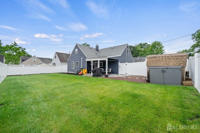 6 Linda Ave, Colonia, NJ 07067 - back of house with a fenced backyard, a storage shed, roof with shingles, a patio, and a gate