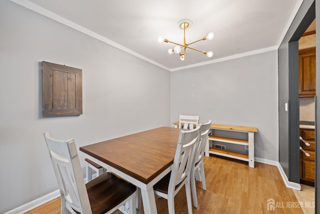 6 Linda Ave, Colonia, NJ 07067 - dining room featuring a chandelier, light wood-style floors, and ornamental molding