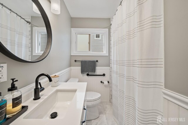 6 Linda Ave, Colonia, NJ 07067 - bathroom featuring marble finish floors, a wainscoted wall, vanity, and a shower with curtain