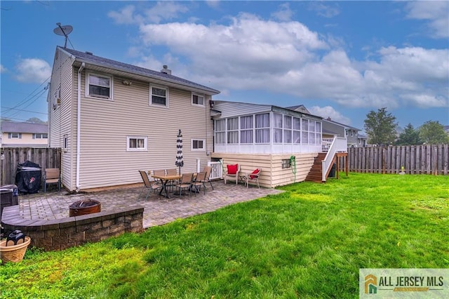 47 Dewitt Ter, Colonia, NJ 07067 - back of house featuring a sunroom, an outdoor fire pit, a fenced backyard, and a patio