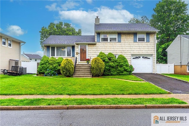 47 Dewitt Ter, Colonia, NJ 07067 - tri-level home featuring a garage, a chimney, and asphalt driveway