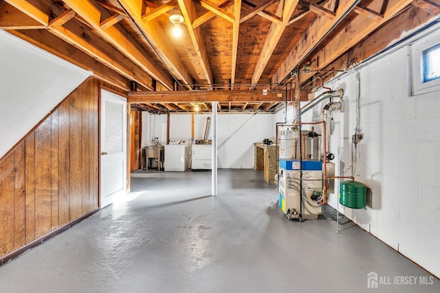 basement with washer and dryer and wooden walls