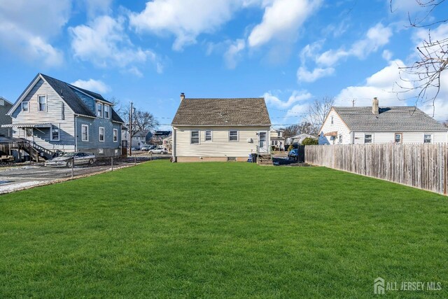 rear view of house featuring a lawn