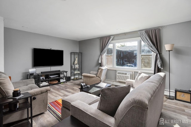 living room with light wood-style floors, a baseboard radiator, and a wall mounted AC