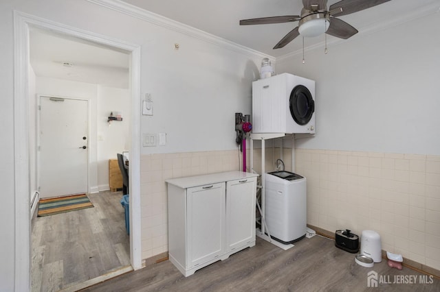 washroom with wainscoting, ornamental molding, tile walls, and wood finished floors