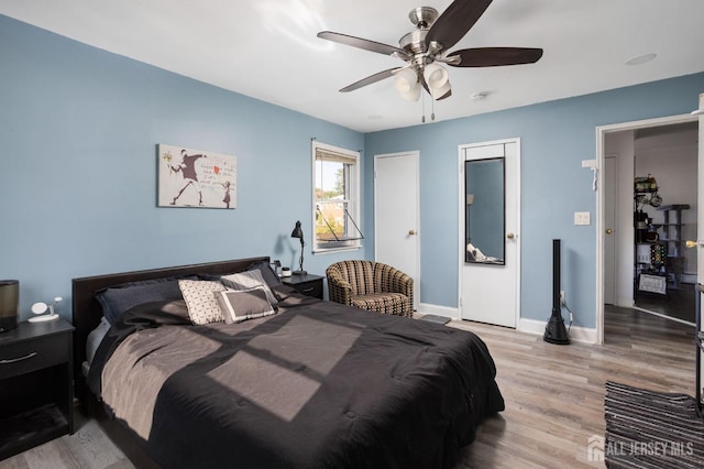 bedroom featuring ceiling fan, wood finished floors, and baseboards