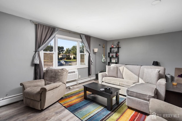 living area with baseboard heating, wood finished floors, and a wall mounted AC