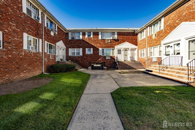 back of house featuring a yard and brick siding