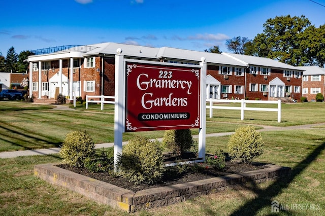 community / neighborhood sign featuring a yard