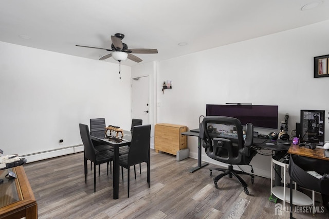 office space with a baseboard radiator, ceiling fan, and wood finished floors