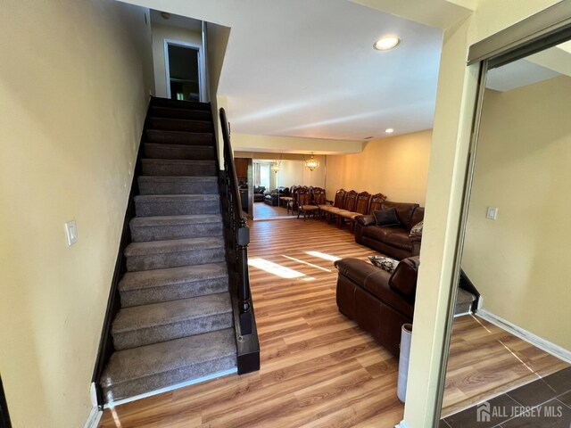 staircase with hardwood / wood-style flooring