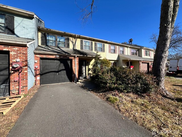 townhome / multi-family property featuring a garage