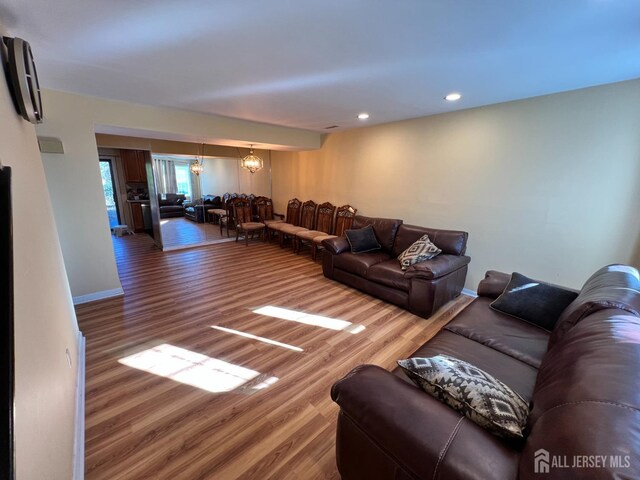 living room featuring hardwood / wood-style floors and a notable chandelier